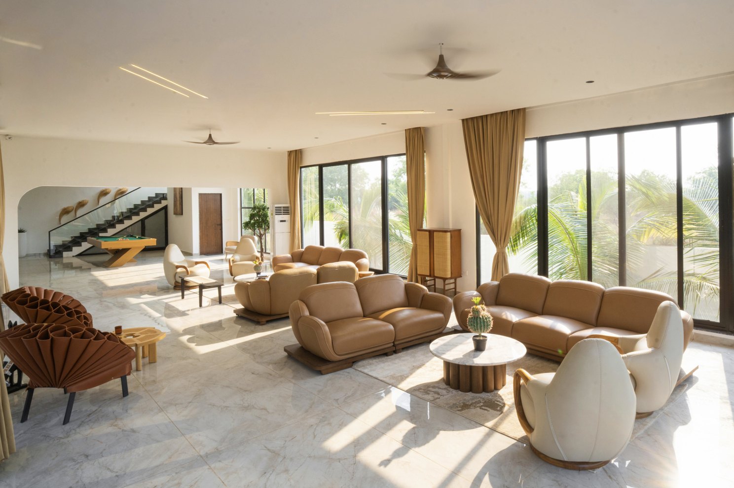 Azure Cove — sunlit living space with lounge seating and palm views