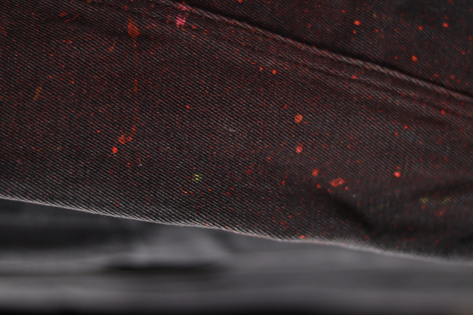 Umca — black fabric with red paint specks